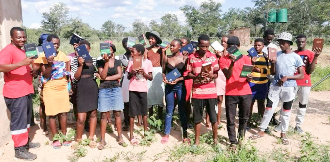 Campers holding Bibles at the Zimbabwe youth camp