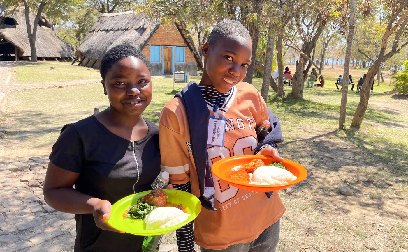 Campers with their meals at the Zimbabwe youth camp