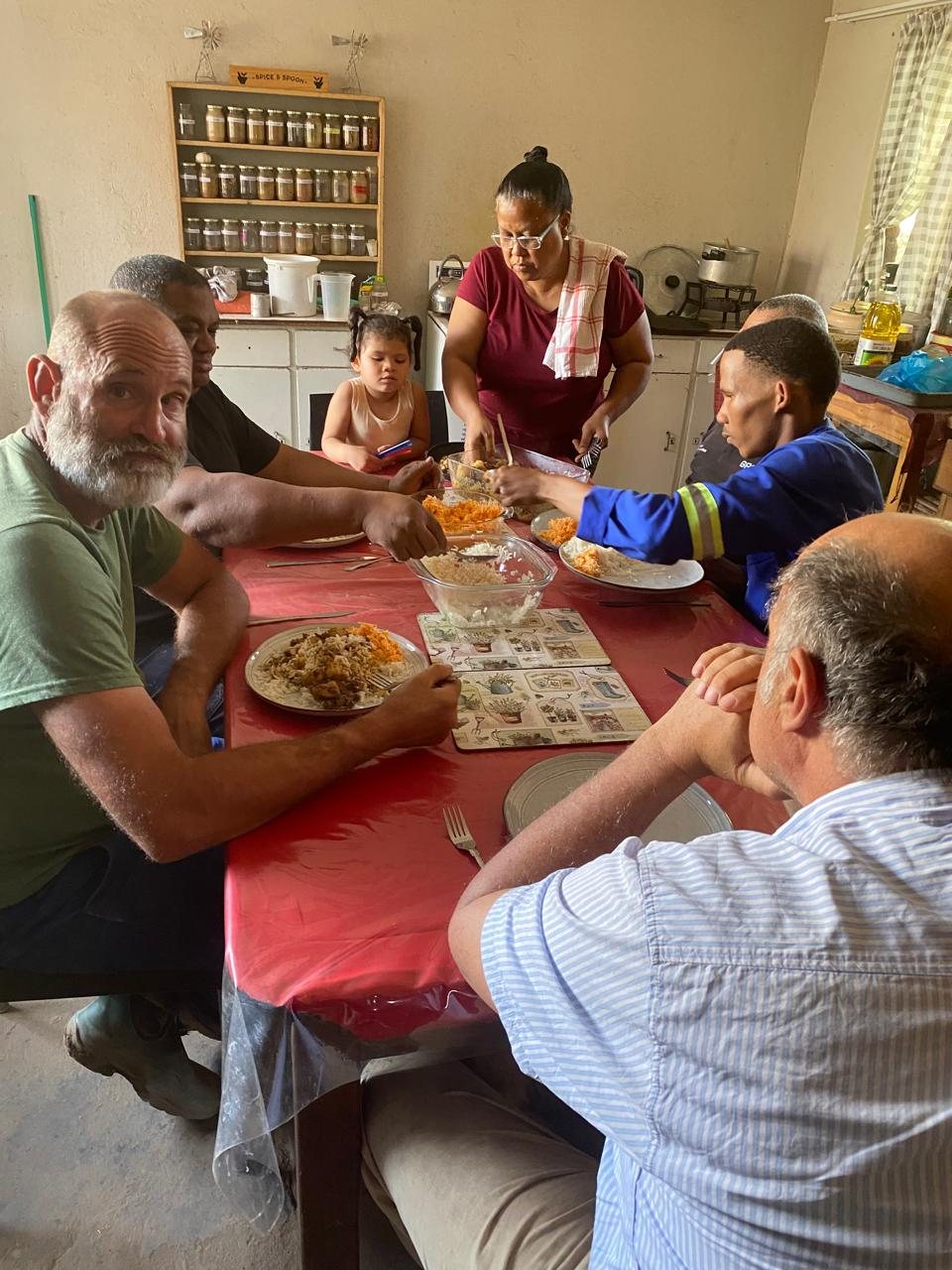 Gerhard le Roux and Riaan Mouton with workers at lunch, Onseepkans