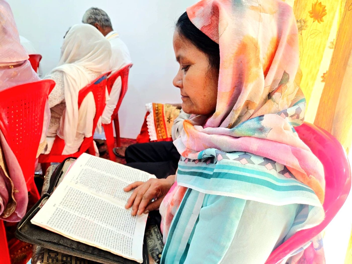 A woman studying the Bible, India